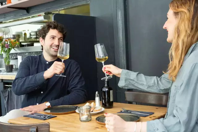 young people enjoying wine together